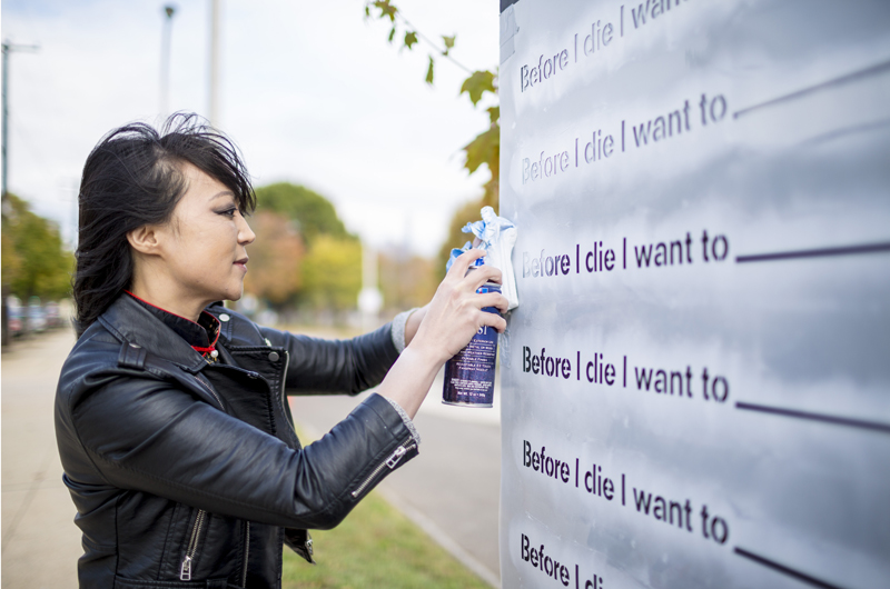 Chang created a "Before I die…" art installation on an 80-foot wall surrounding the construction site of the former University City High School. Photo credit: C. Shan Cerrone.